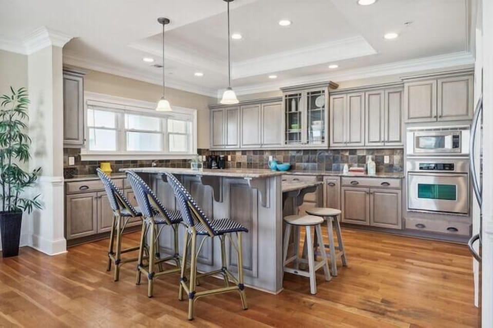 This enormous kitchen has island seating for 5 & plenty of counter space for multiple cooks or bar tenders.