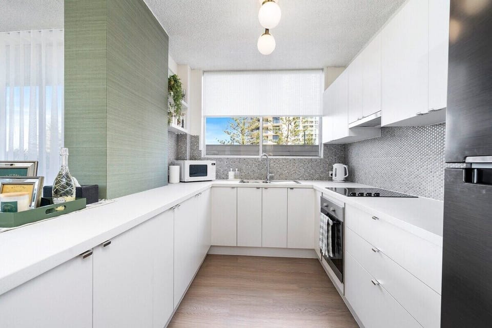Full gourmet kitchen with stove, oven and refrigerator.