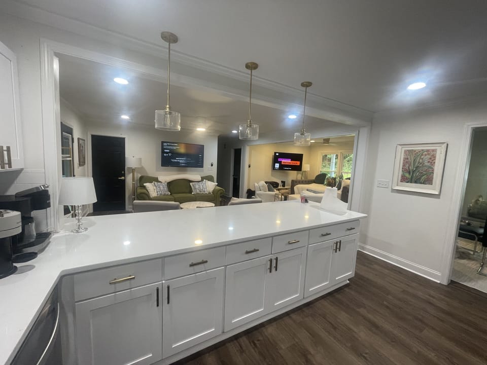 Two living areas are open to the kitchen and the dining room.