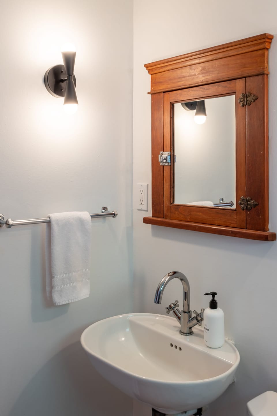 Original built in cabinet mirror in the main level bathroom.