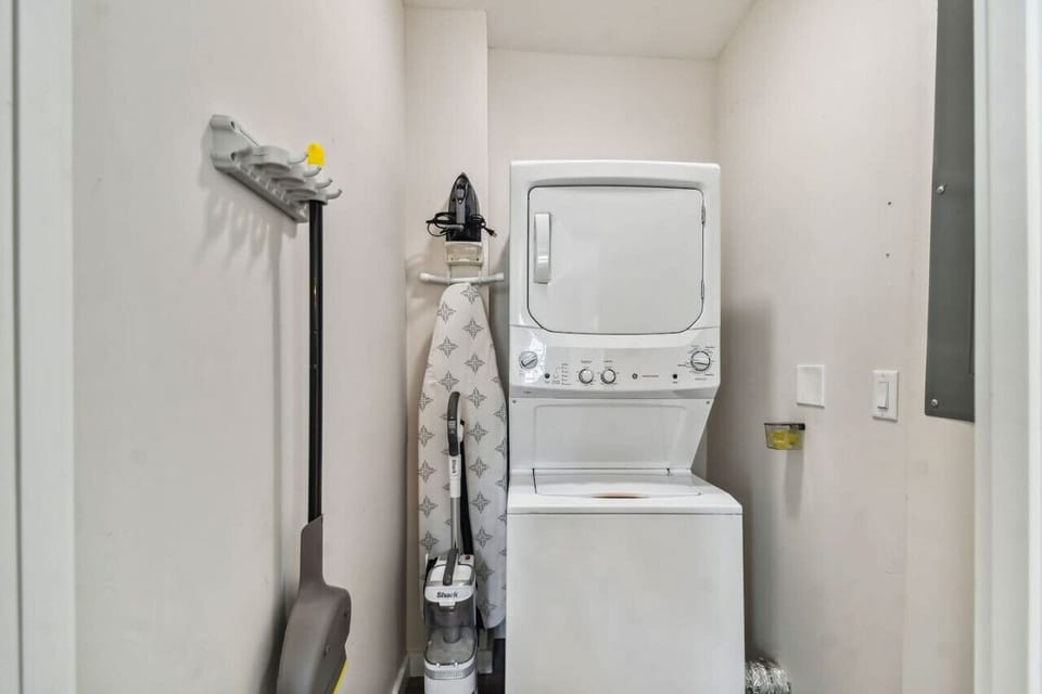Laundry room with complimentary detergent pods, iron with ironing board and vacuum!