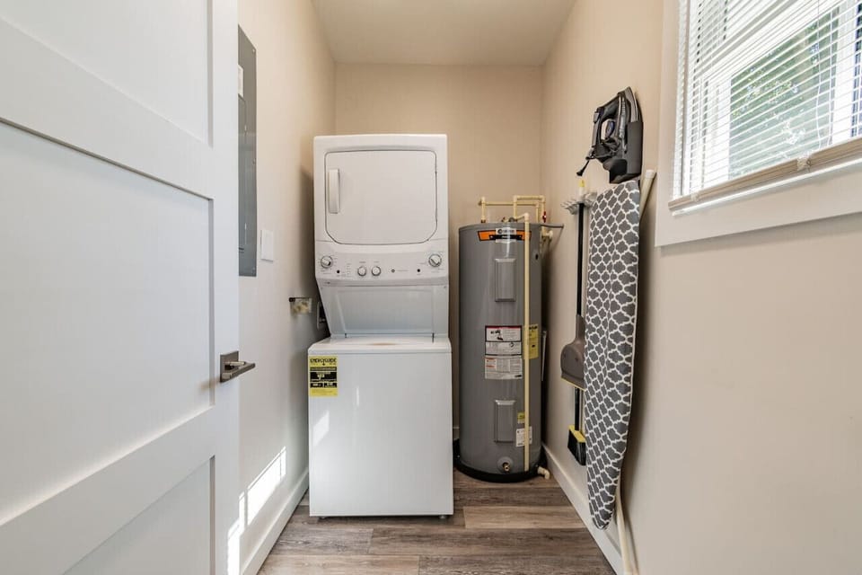 Laundry room with complimentary detergent pods, iron with ironing board and vacuum!