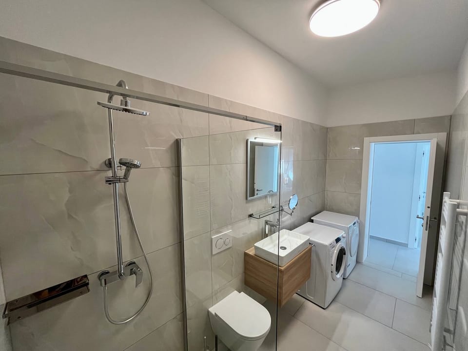 Full bathroom with washer and dryer