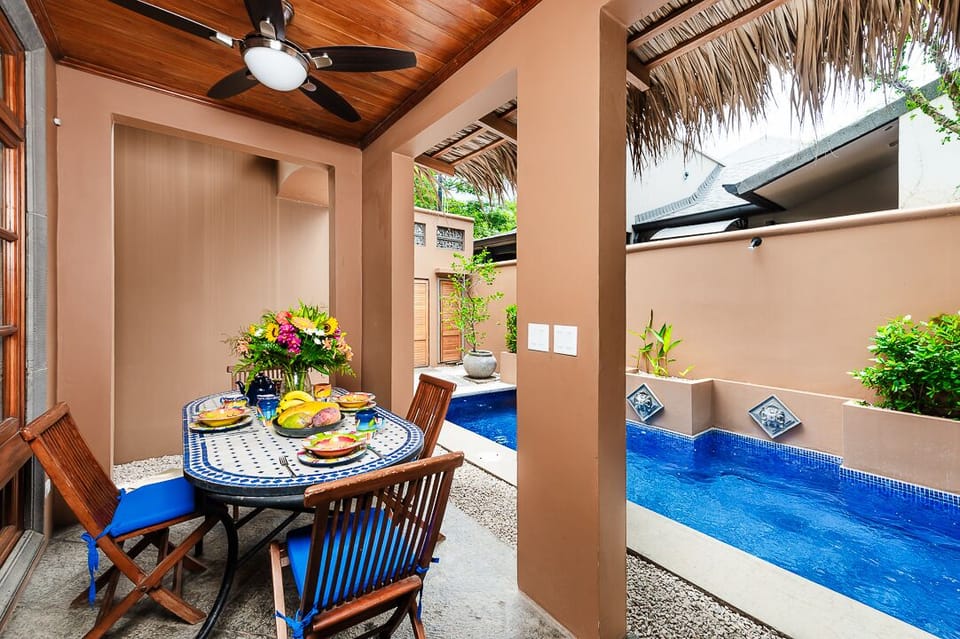 Charming poolside terrace with dining area at a luxury villa in Langosta Beach, Tamarindo. Ideal for family gatherings or relaxing in a tropical setting, perfect for an unforgettable Costa Rica vacation experience.