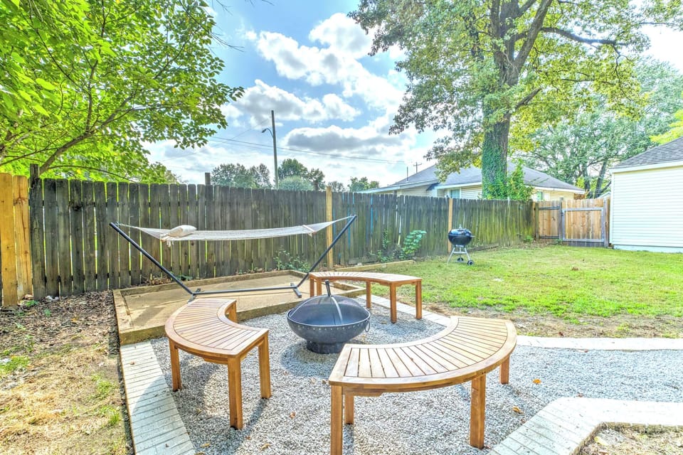 fire pit and benches in backyard patio, plus hammock and grill