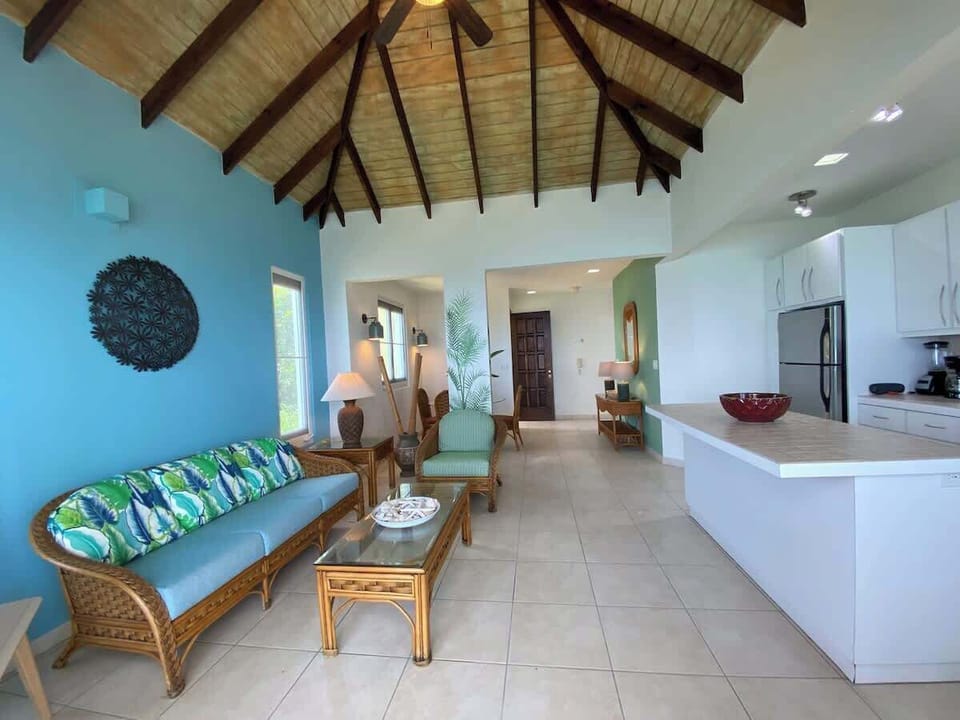 View of the open plan living area showing kitchen area with kitchen island. 