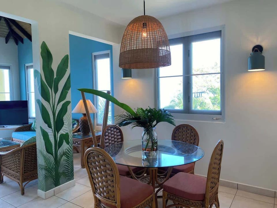 Close-up of dining area with living room in background.