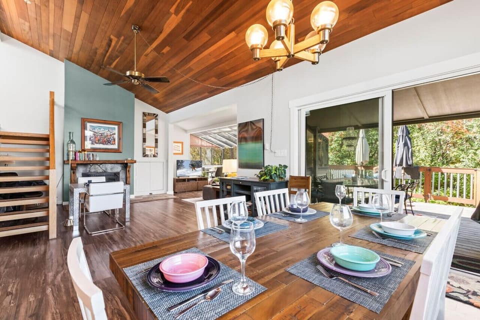 Enjoy the spacious great room with the sun room addition with the beauty of the forest outside and the warm fire inside