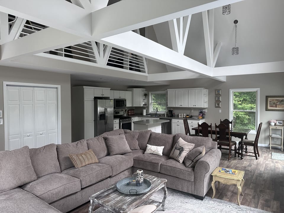living area on main floor with open ceiling and natural light 