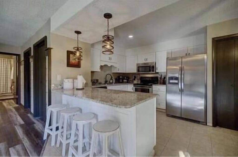 Kitchen: Modern design with stainless steel appliances and elegant bar seating, perfect for gatherings!
