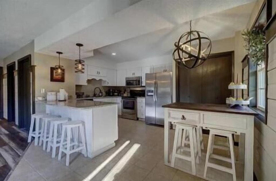  Illuminate your culinary adventures in a stylish, modern kitchen with ample space!