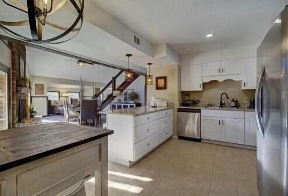 Sunlit space with modern appliances and rustic charm, perfect for culinary adventures!