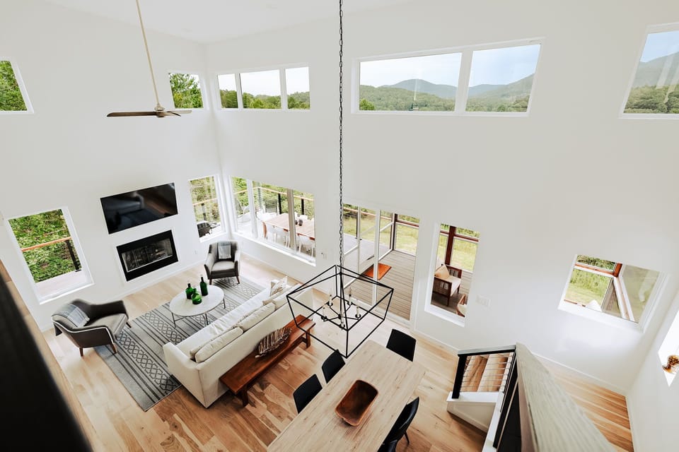 Let the light pour in. This airy great room with gas fireplace, massive windows, and stylish décor sets the scene for connection and relaxation.