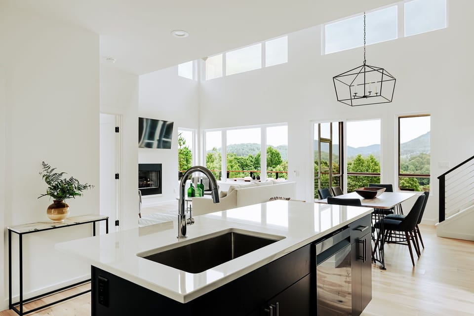 Soaring ceilings, sleek design, and panoramic views. This open-concept living space is the heart of your mountain stay.