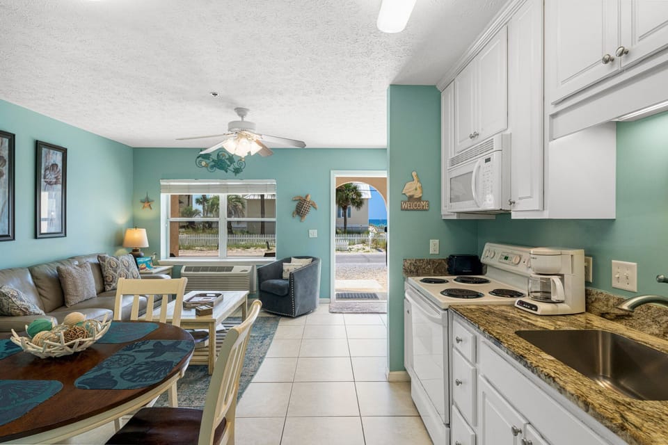 Bright, functional kitchen flowing into the living space — easy for cooking & entertaining.
