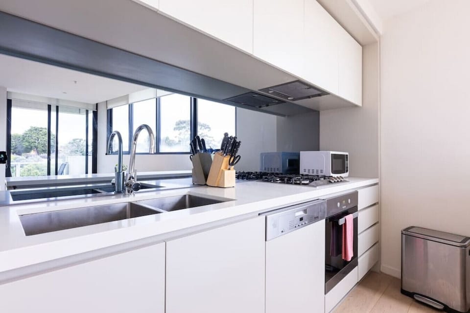 Modern fully equipped kitchen with cooking appliances, microwave, pots, pans and plenty of cooking utensils for the times you just want to stay in.