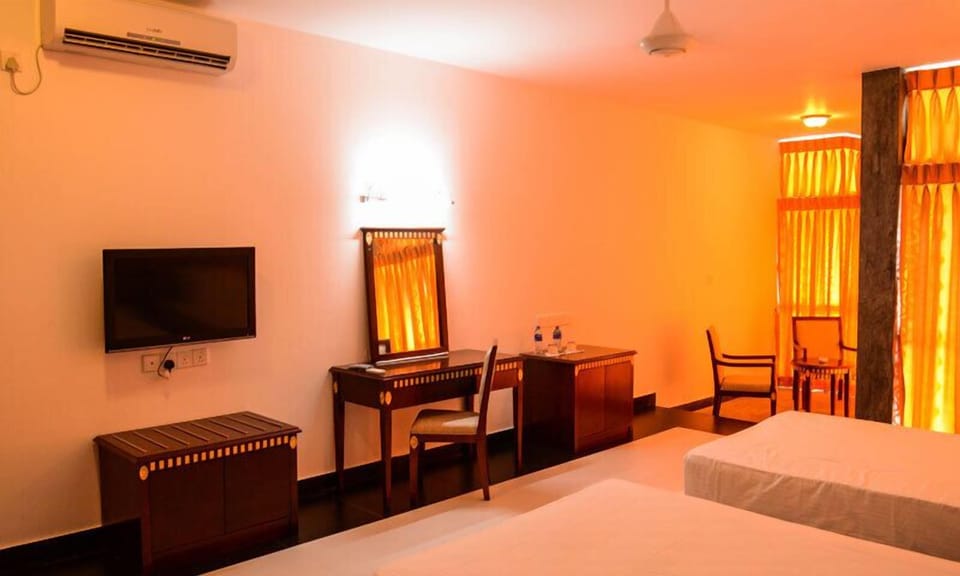 Deluxe Double Room, 1 Bedroom, Beach View | 1 bedroom, in-room safe, desk, iron/ironing board