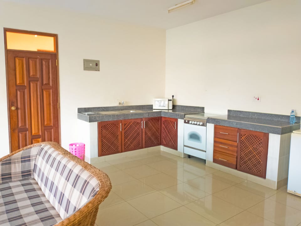 Basic Apartment, Pool View | Living area | Flat-screen TV
