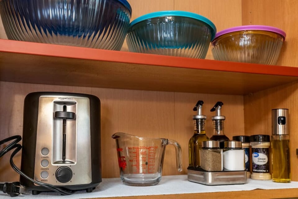 Stocked kitchen: oil, vinegar, salt/pepper, toaster, mixing bowls, etc.