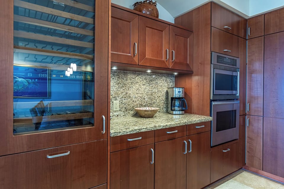 Your fully equipped kitchen features warm wood cabinetry, granite countertops, and stainless steel appliances, making meal prep a breeze during your stay.