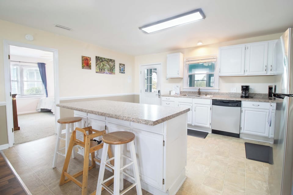 Your fully equipped kitchen features granite counters, modern appliances, and a convenient breakfast bar - perfect for preparing meals and morning coffee together.