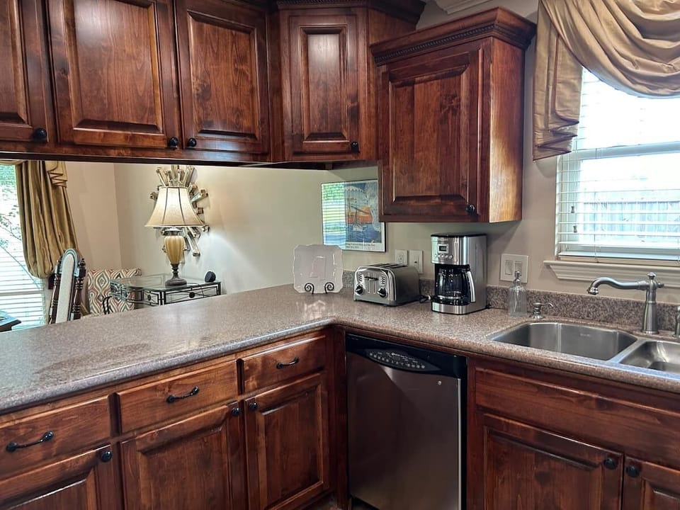 Large kitchen with dishwasher with view looking into dining room.