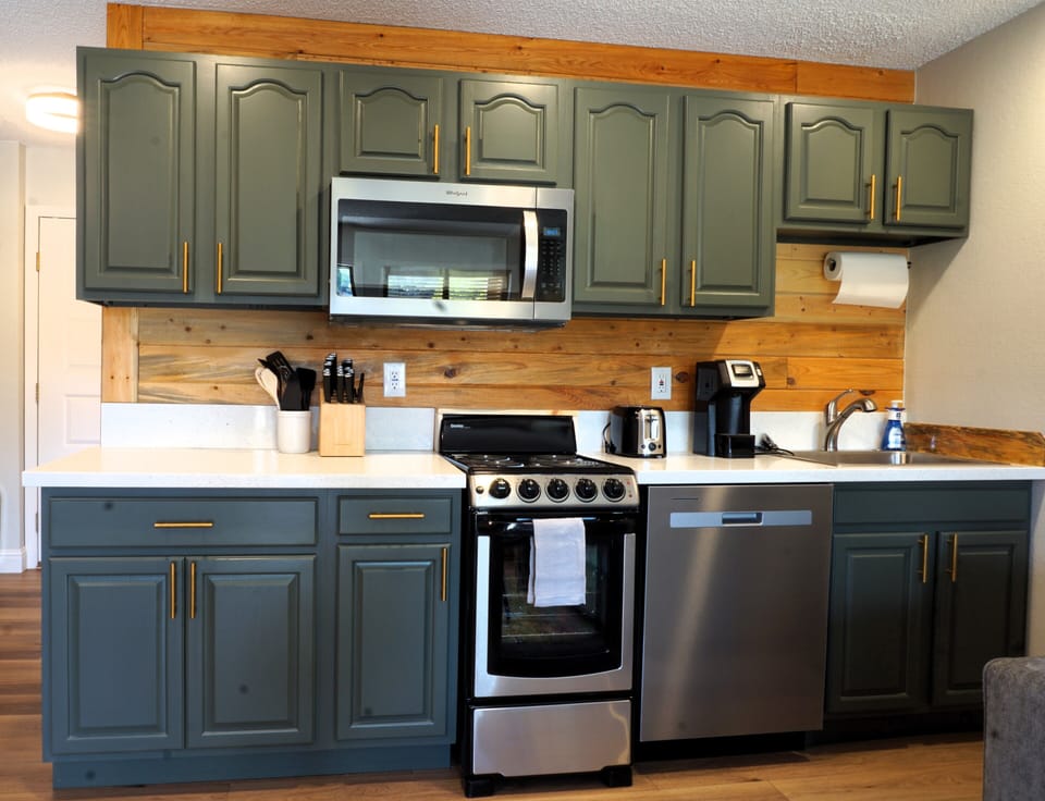 Well stocked kitchen with dishes, stove/oven, dishwasher
