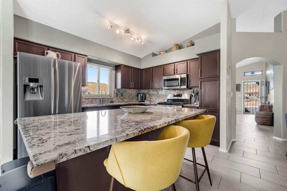 Kitchen with granite island—perfect for cooking, entertaining, and gathering.