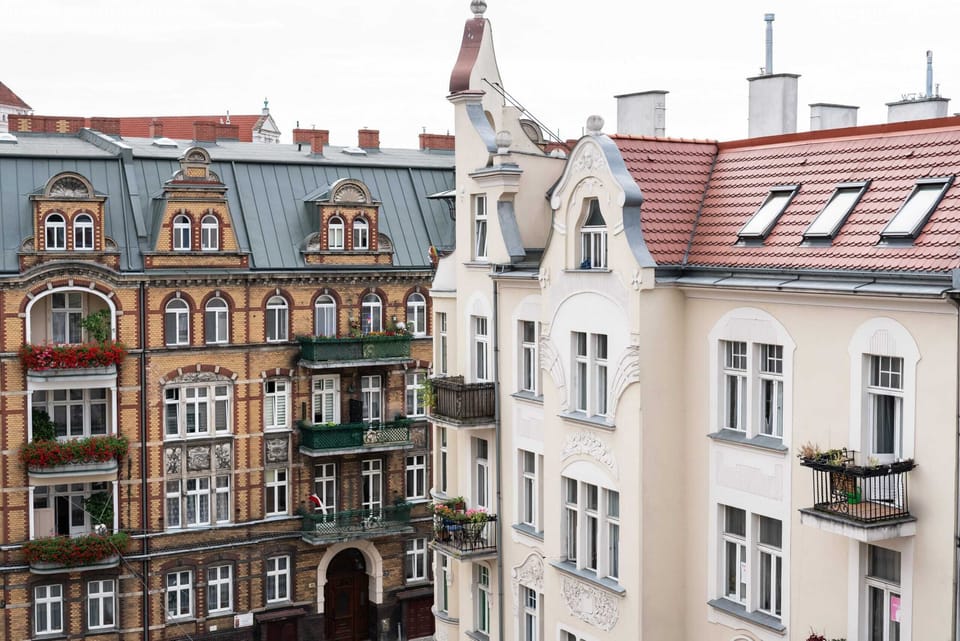 A view from the window overlooking a charming street with historic architecture and colorful facades.
