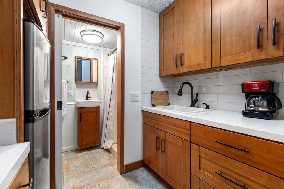 Bamboo cabinets / white quartz countertops.