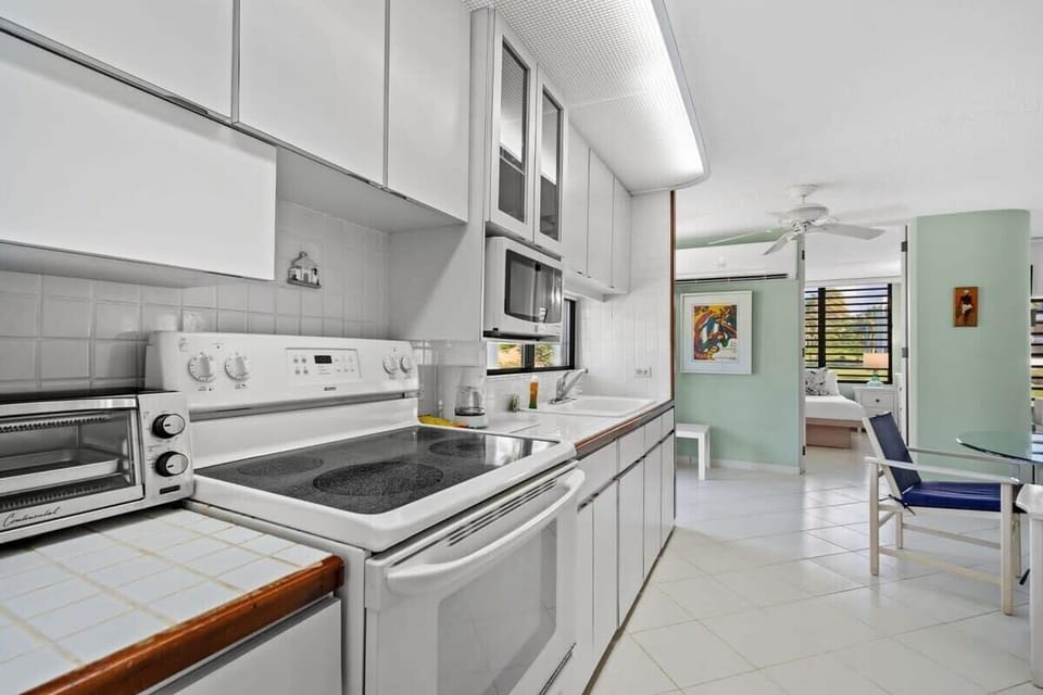 The fully equipped kitchen features a stove, oven, toaster oven, coffee maker and microwave.