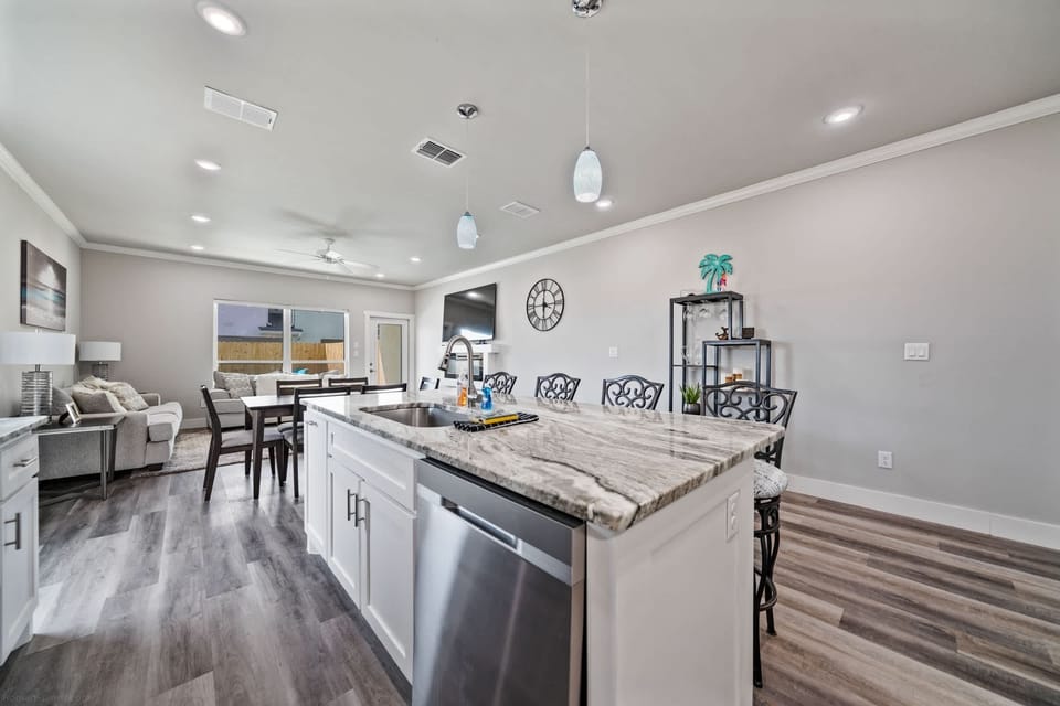 An open layout connects the kitchen, dining, and living areas