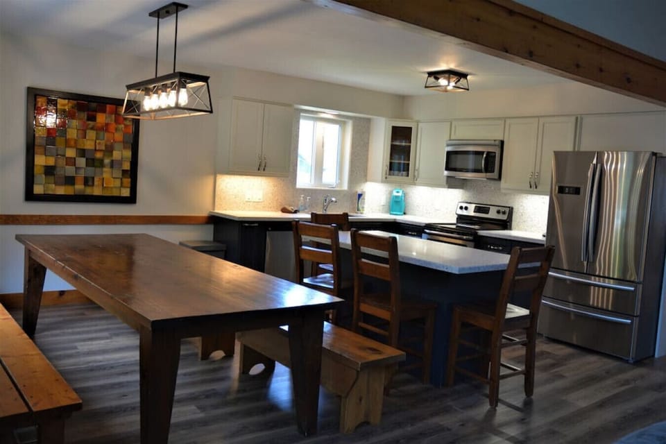 Standing off to the righ-hand side of the dining table looking towards the kitchen
