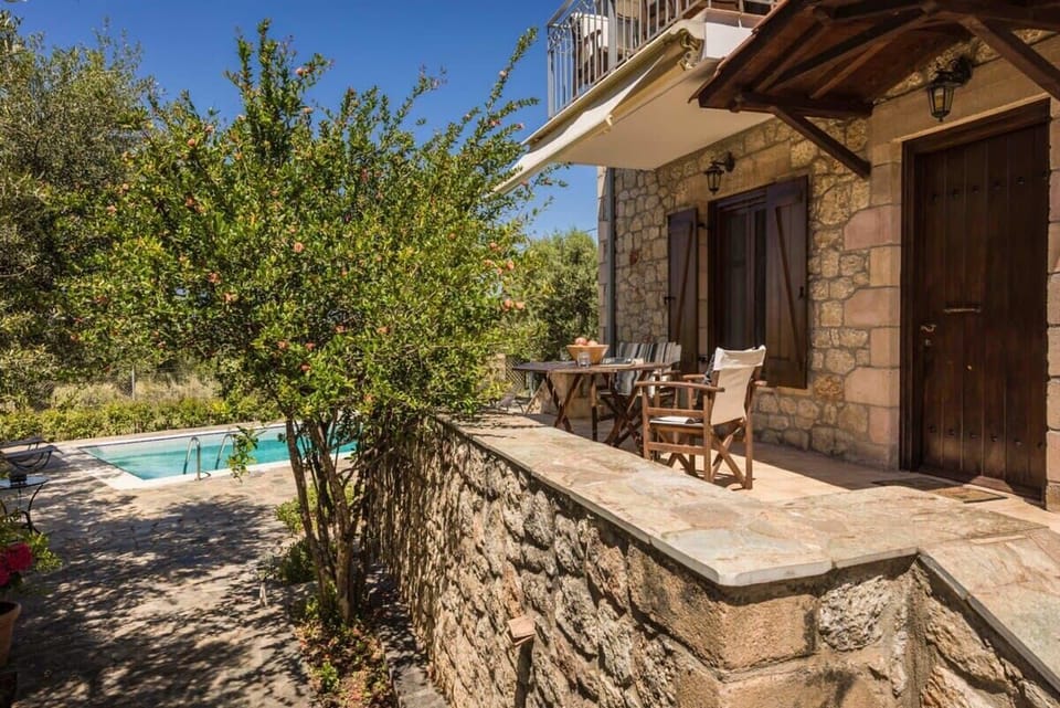 Exterior Patio of the House – Stone-paved terrace with a peaceful garden view.