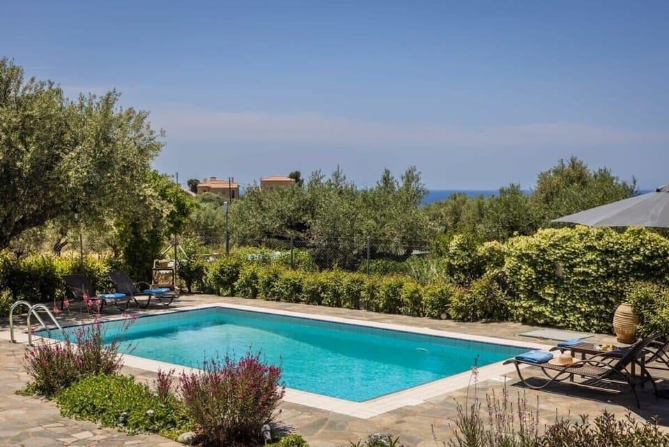 Exterior Shared Pool – Inviting pool area blending stone architecture with natural greenery.