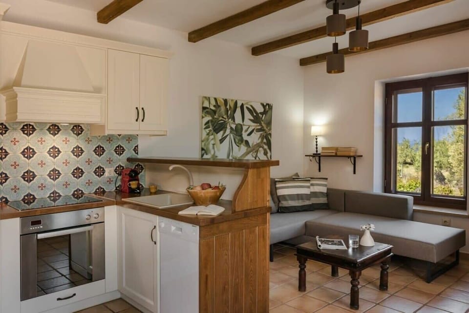 Interior Space – Fully Equipped Kitchen – Traditional Cretan kitchen with modern appliances and warm, rustic design.