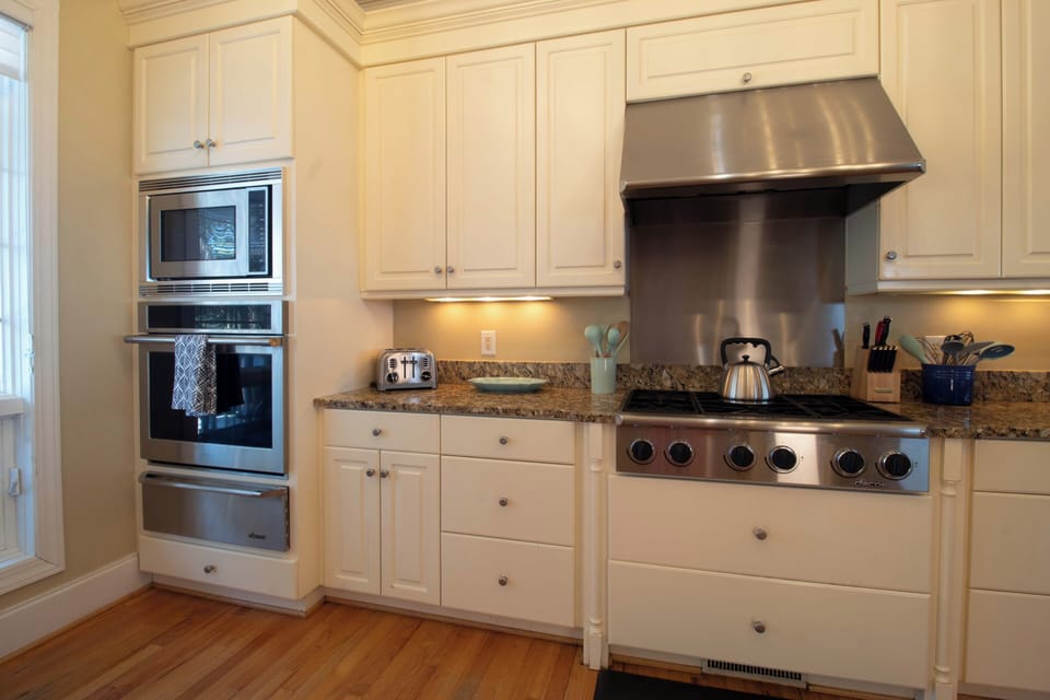 Your gourmet kitchen awaits with stainless appliances, granite counters, and warm cream cabinetry for culinary adventures.