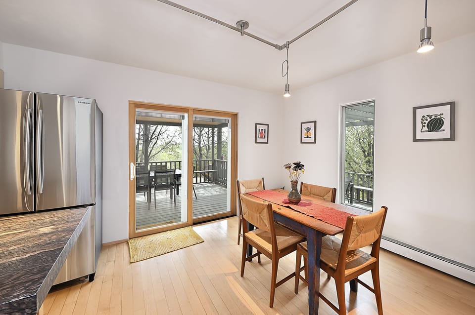 Kitchen dining with patio doors leading to outside dining