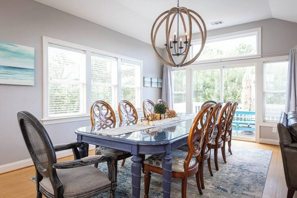 Top Level: Dining area with large table that seats 10, plus access to the sun deck with a picnic table -great for group meals and dining outdoors