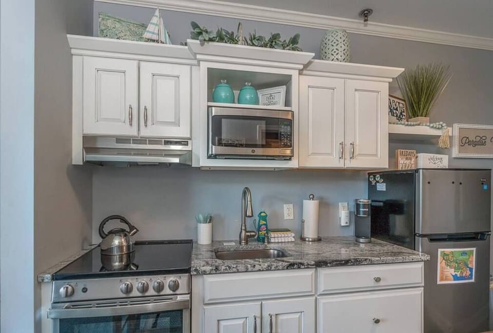 Fully Stocked Kitchen  w/ Breakfast Bar, Refrigerator, Microwave, Oven, Stove, Dishwasher, Coffee Maker, Cooking Utensils and Light Blue Accent Walls