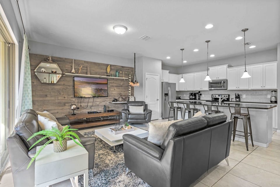 Open kitchen w/ sleek cabinets, island seating & plenty of space to cook & gather.