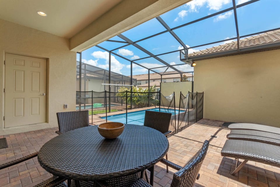 Covered patio dining area ideal for laid-back meals & conversations outdoors.