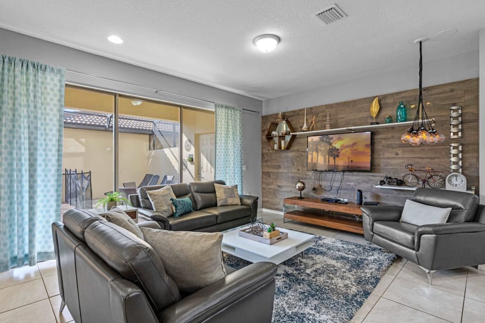 Open living area w/ comfy seating flows into a bright, well-equipped kitchen.