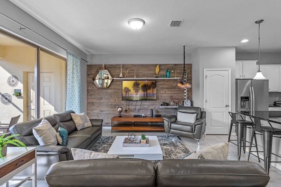 Inviting living room w/ plush seating, warm lighting & an easygoing layout to unwind.