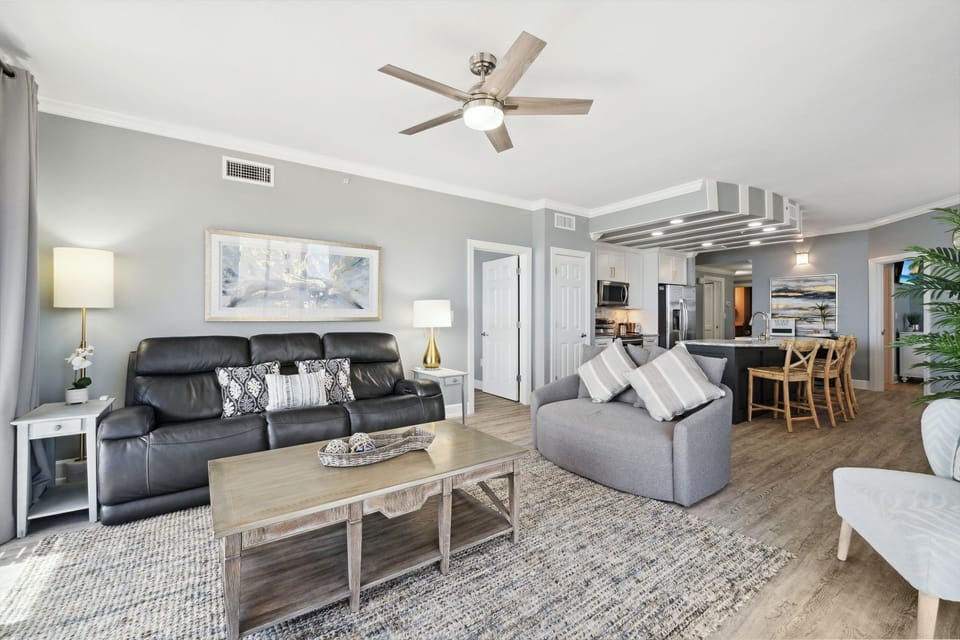 Gulf-front living space with plush seating, Smart TV, and direct balcony access