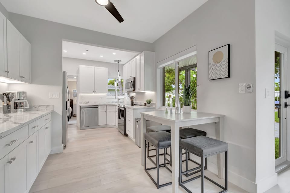 The kitchen and breakfast bar give you a bright, practical place for coffee, quick meals, and easy conversation.