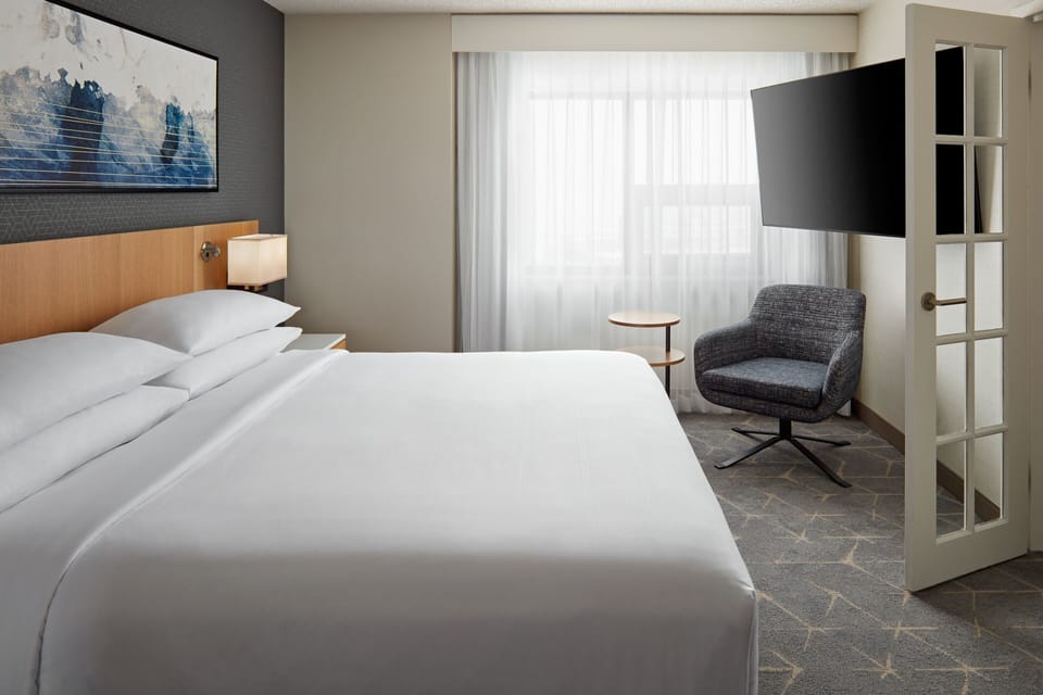 Premium bedding, desk, laptop workspace, blackout drapes