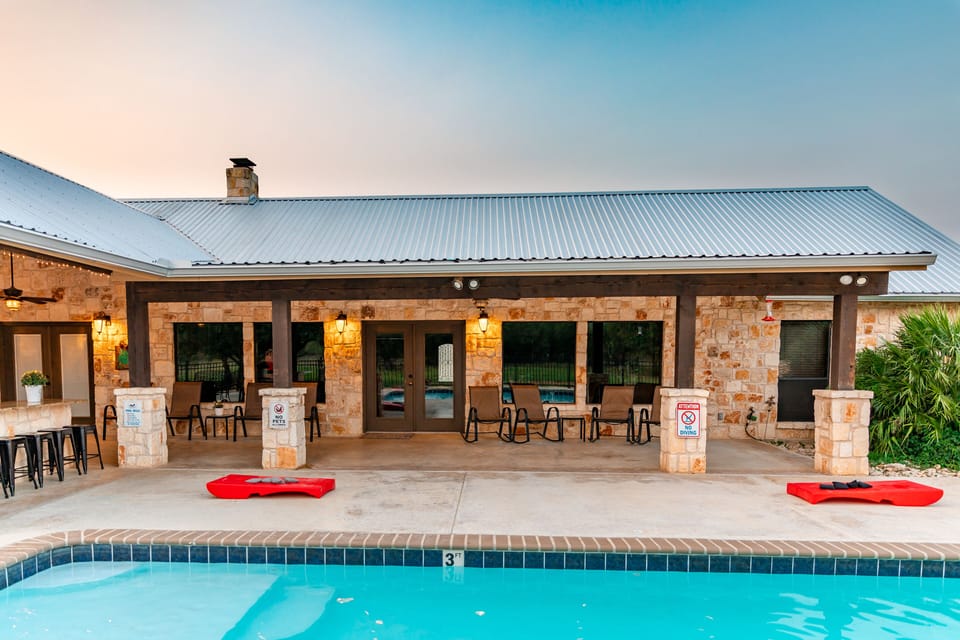 The wraparound patio roof keeps the sun off your shoulders + ceiling fans.