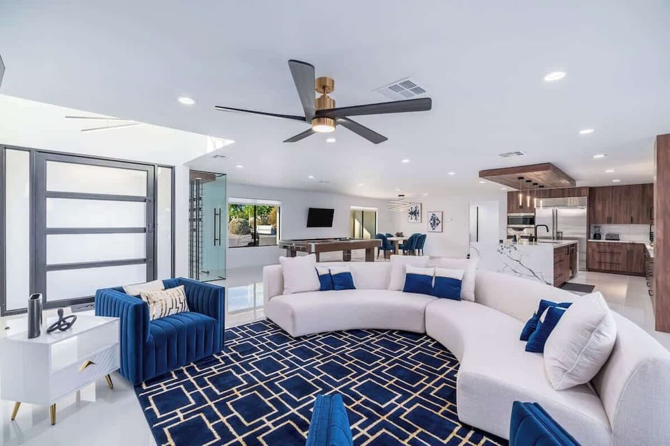 Unwind in this sleek open-concept living space, where modern comfort meets style. Sink into plush seating, enjoy your favorite shows, and savor the seamless flow from lounge to kitchen.