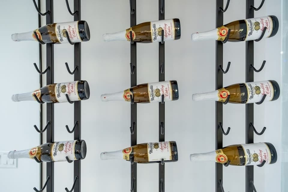 A sleek wall-mounted rack displays a curated selection of bottled beverages, ready to complement your stay with refreshment and style.